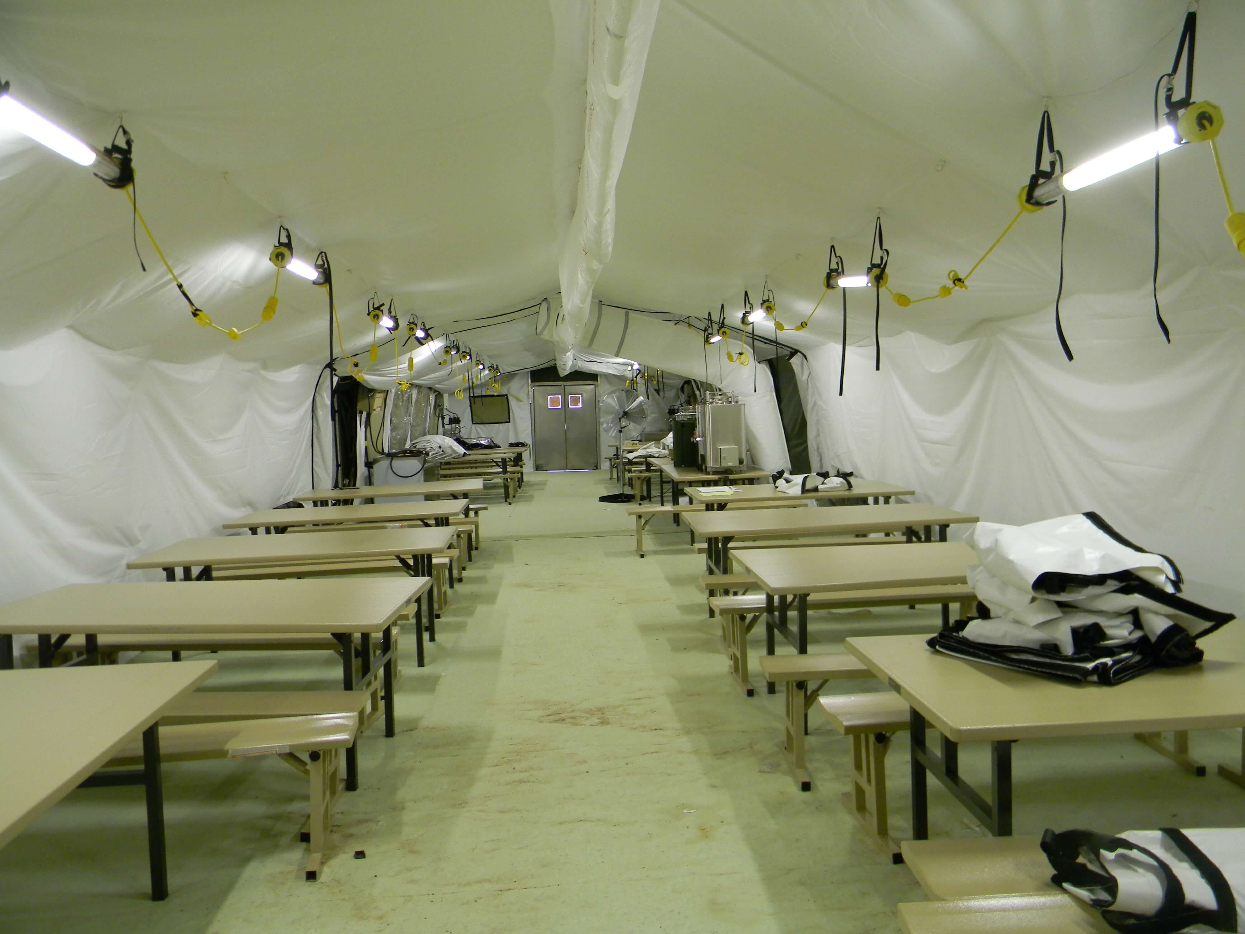 CAMSS: Interior View of CAMSS 20EX40 Military Shelter Systems with Tan Tables